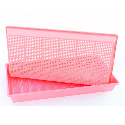 Plastic trays with a grid pattern, showing a pale pink color and a rectangular shape, stacked on a white background