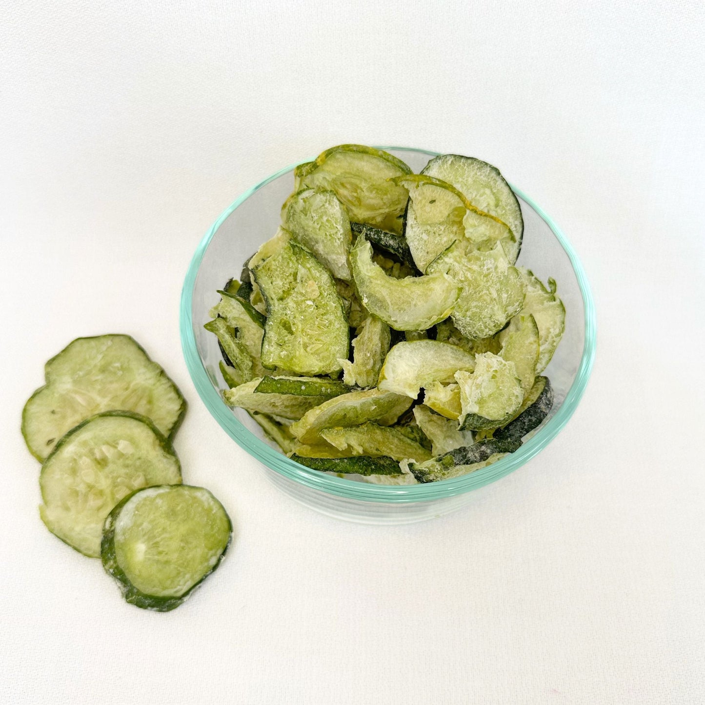 Crunchy freeze-dried Ranch Cucumber Chips by Double L Ranch, showing vibrant green cucumber slices with ranch seasoning.