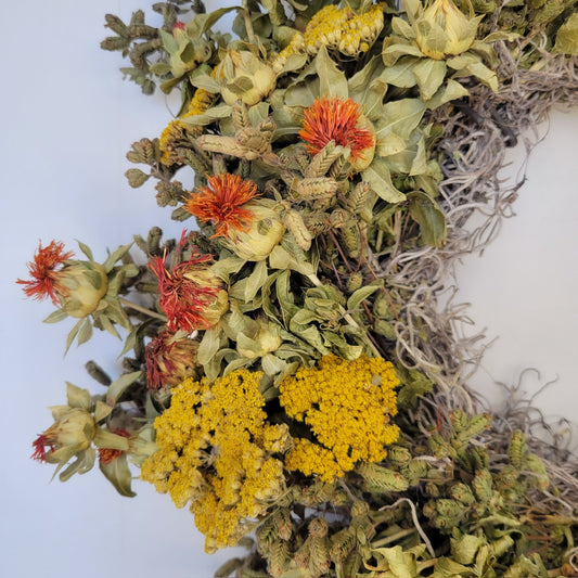 Handmade dried flower wreath with vibrant orange blooms from Sunny Meadows Flower Farm, showcasing natural floral arrangement.