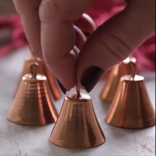 Sertodo Copper Mantra Bell with intricate engraved patterns and a sturdy handle, used for spiritual or decorative purposes.
