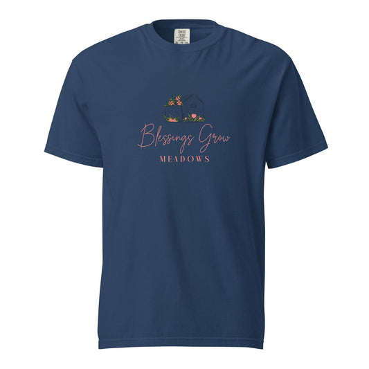 Comfort Colors t-shirt featuring Blessings Grow Meadows logo design showing a dark house with pink flowers and green grass