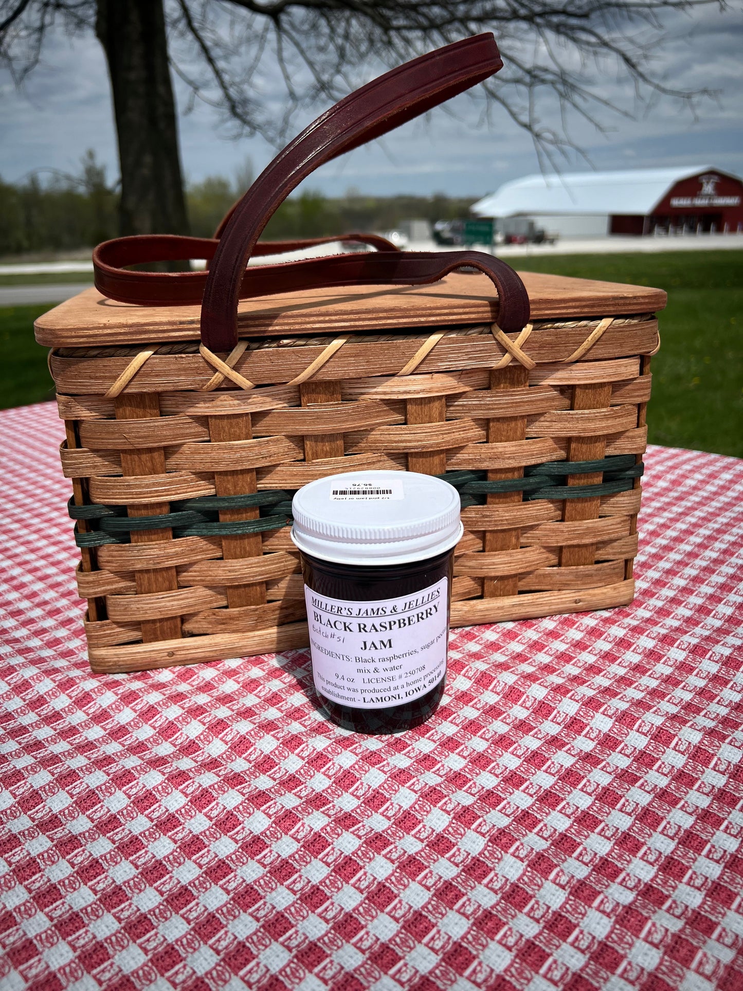 Amish Black Raspberry Jam by Amish Country Store in a glass jar with a label, showcasing fresh black raspberries and jam spread.