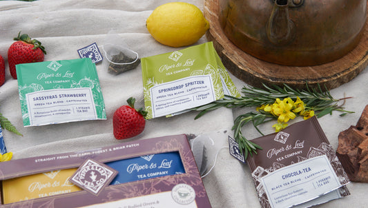 Assorted caffeinated tea bags from Piper and Leaf Tea Co. arranged in a tasting flight box with 12 tea bags for sampling.
