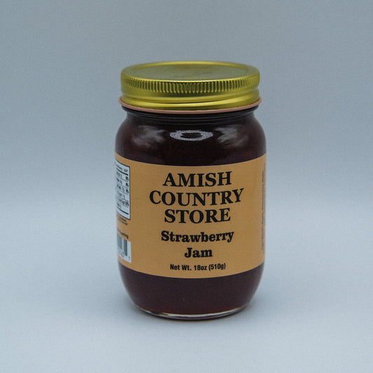 Canned strawberry jam in an 18oz jar from Amish Country Store, showing a close-up of the jam with fresh strawberries.