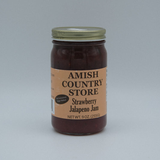 Canned Strawberry Jalapeno Jam by Amish Country Store in a 9 oz jar, showing fresh strawberries and jalapenos on the label.