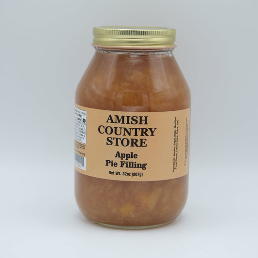 Canned Amish Country Store apple pie filling in a jar with a label, showcasing golden apple chunks in syrup.