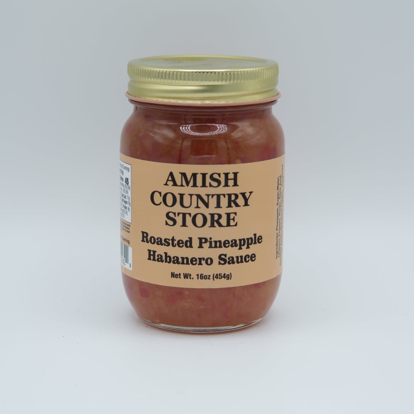 Canned roasted pineapple habanero sauce in a 16oz jar from Amish Country Store, showcasing the vibrant sauce with pineapple and peppers.
