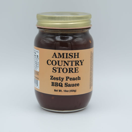 Canned Zesty Peach BBQ Sauce by Amish Country Store in a 16 oz jar, showcasing fresh peaches and rich barbecue flavor.