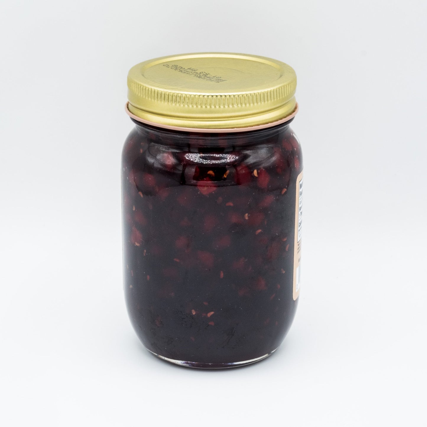 Amish Country Store Bear Jam canned goods jar with orange bear label and 18 oz size on a kitchen countertop.