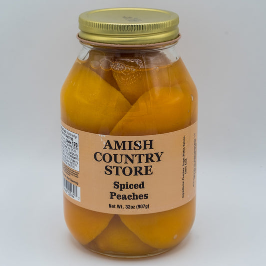 Canned Spiced Peaches in a 32oz jar from Amish Country Store, showcasing ripe peaches with spiced syrup in a glass jar.