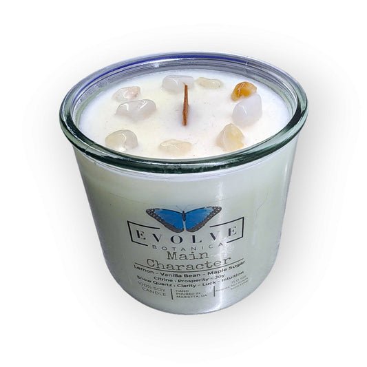 Evolve Botanica Rocks Candle Main Character with wood wick, citrine, and snow quartz gemstones in a soy candle holder.
