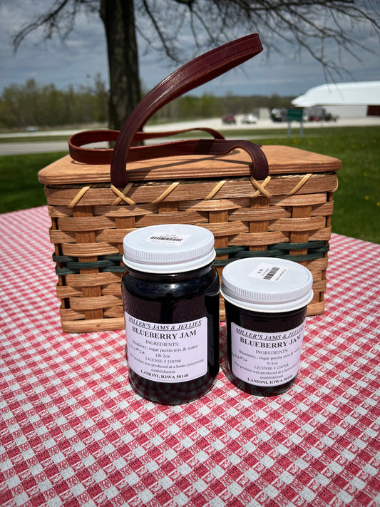 Jar of Miller's Blueberry Jam from Amish Country Store, featuring fresh blueberries in a clear glass jar with a label.