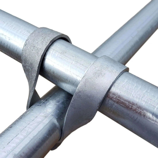 Close-up photograph showing galvanized steel pipe joints with textured metal bands exhibiting a matte finish and subtle metallic sheen