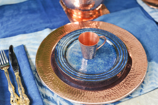 Hammered copper Thessaly 13-inch charger plates by Sertodo, showcasing a textured, decorative copper plate for elegant table settings.