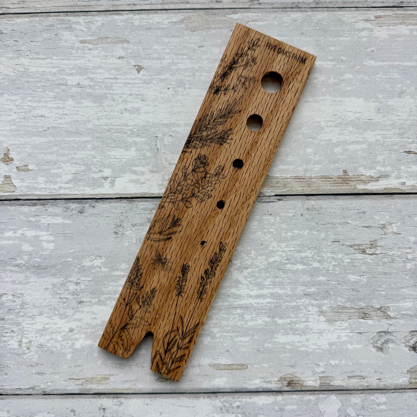 Five Oaks Farm Herb Stripper with multiple stainless steel holes for efficiently stripping herbs and greens.