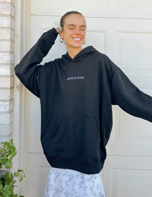 Black unisex hoodie featuring religious artwork inspired by Jesus Is King, by Elevated Faith, with a comfortable fit and casual style.