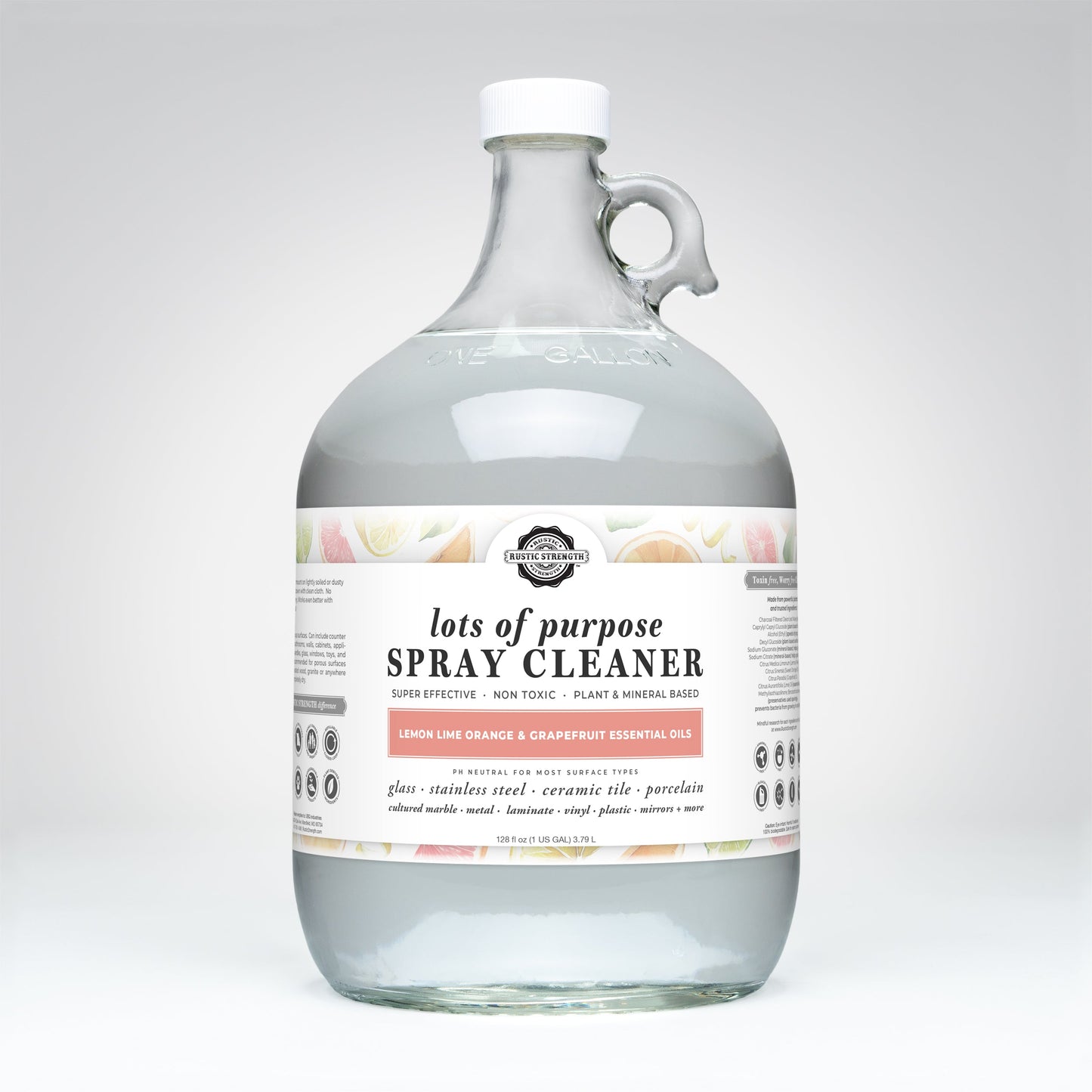 A clear 1-gallon glass jug of Rustic Strength Lots of Purpose Spray Cleaner | Lemon, Lime, Orange & Grapefruit—a plant-based, toxin-free cleaner for glass, tile, porcelain, and stainless steel with citrus graphics.
