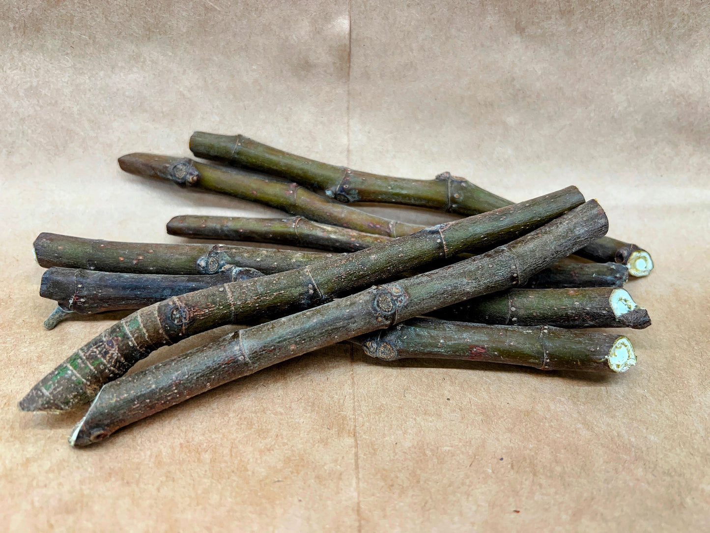 Fresh Marseilles figs from The Farm On Central, showing ripe, purple figs with green stems on a natural background.