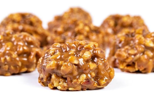 Chewy pecan pralines from Millican Pecan, individual pecan treat with caramelized coating and crunchy pecan pieces.