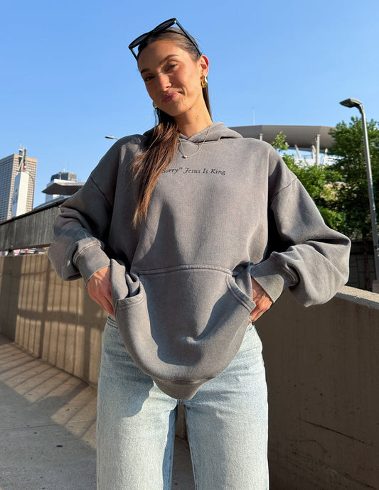 Unisex hoodie by Elevated Faith featuring the "Not Sorry Jesus Is King" design, made of soft fabric with a casual fit.