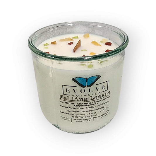 Evolve Botanica Rocks Candle Falling Leaves with gemstones, soy wax, wood wick, featuring peridot, red jasper, and yellow aventurine.