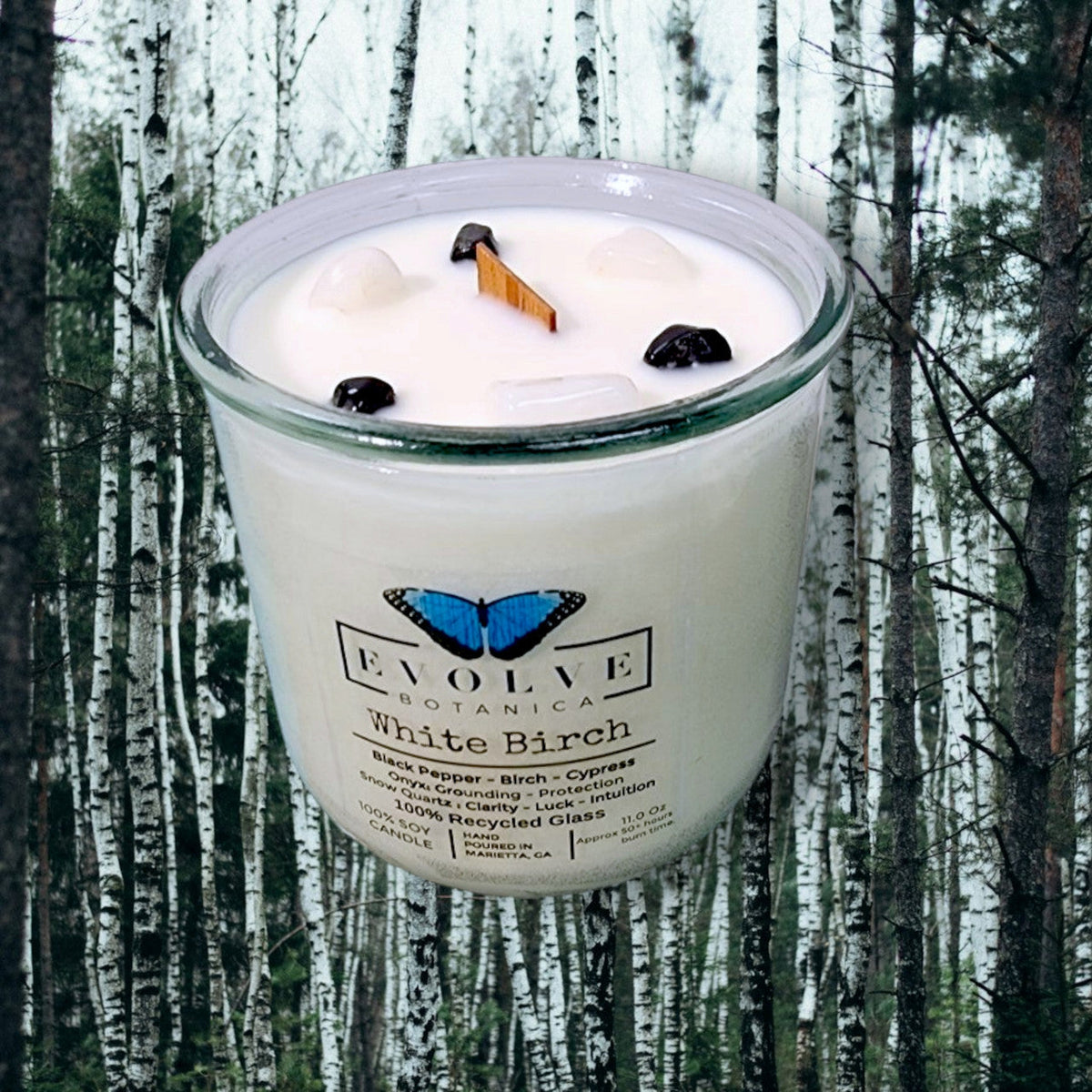 White Birch Rocks Candle by Evolve Botanica featuring snow quartz, onyx gemstones, soy wax, wood wick, and a minimalist design.