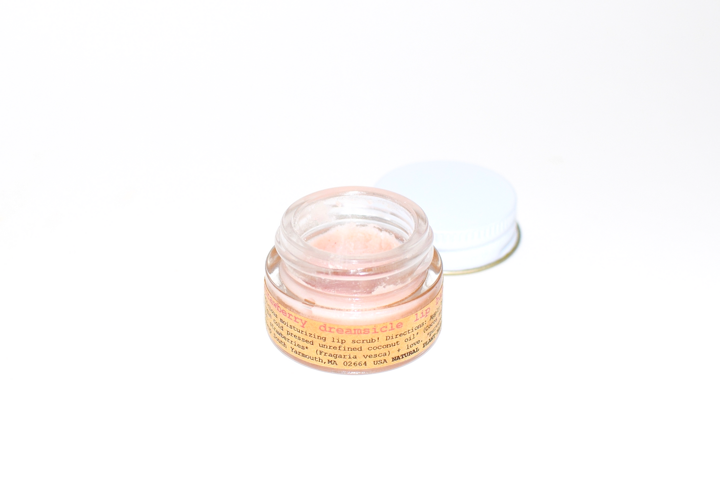Plant Makeup Strawberry Dreamsicle Lip Balm Scrub with a jar of pink lip scrub and natural ingredients on a white background.