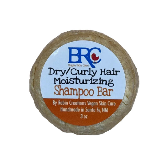 By Robin Creations moisturizing shampoo bar for dry and curly hair, shown with a lathered, textured soap bar on a neutral background.