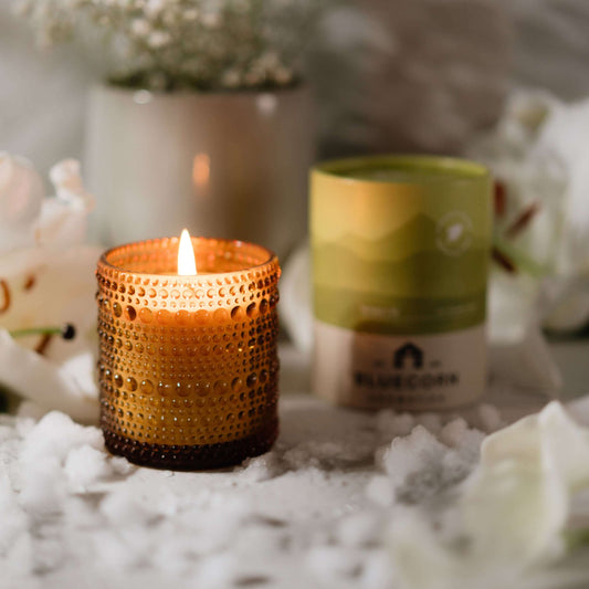 Bluecorn Candles White Lily scented candle in clear glassware with a white lily flower design for elegant home fragrance.