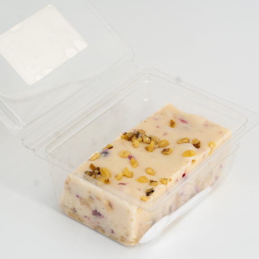 Cranberry Walnut Honey Fudge by Aquidneck Honey showing a square piece with cranberries and walnuts on top