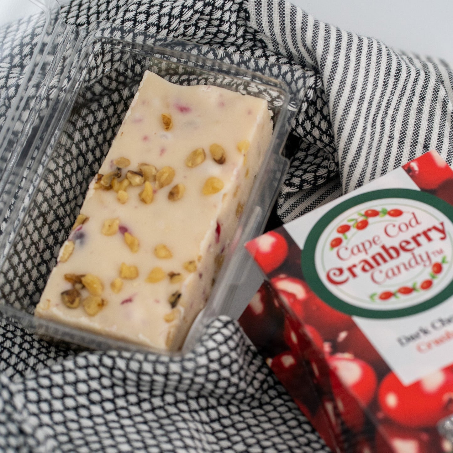 Cranberry Walnut Honey Fudge by Aquidneck Honey showing rich, smooth fudge with visible cranberries and walnuts on top.