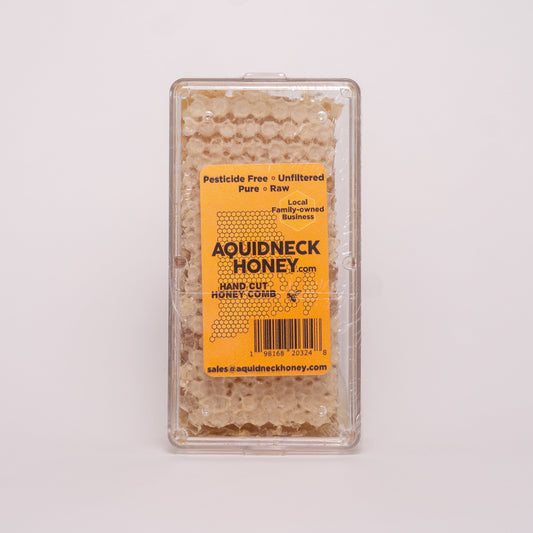 Aquidneck Honey New England hand-cut honey comb showcasing golden honey-filled beeswax with natural texture and hexagonal pattern.