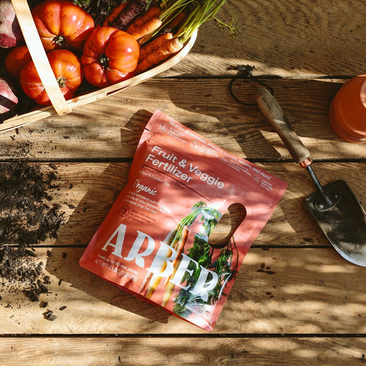 Organic fruit and vegetable fertilizer by Arber, showing a bag of natural plant nutrients for healthy produce.