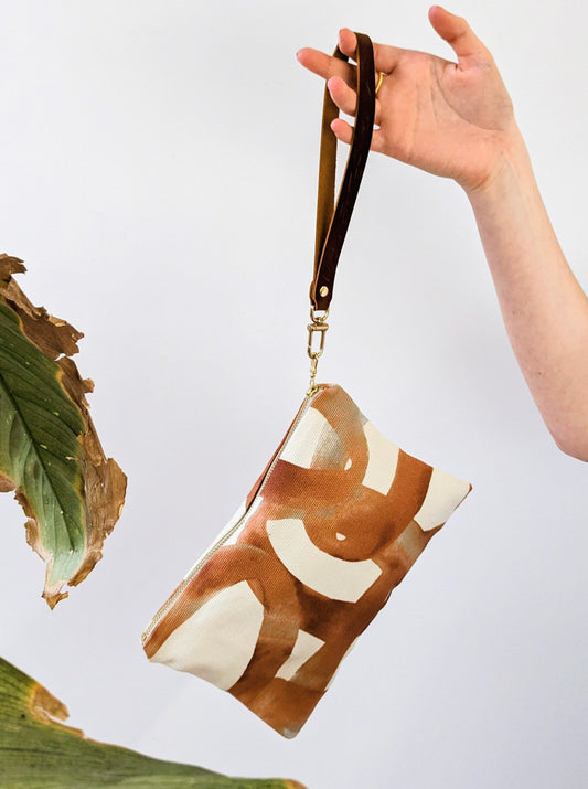 Ash & Rose Shipwreck Chain Wristlet Purse with chain strap and textured exterior, ideal for carrying essentials.