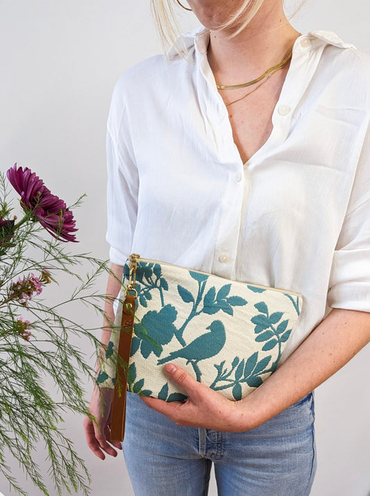 Ash & Rose bird silhouette wristlet purse featuring a sleek design and compact size, perfect for stylish carrying.
