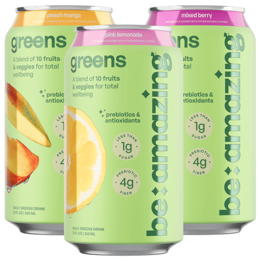 Be Amazing Daily Greens RTD pink lemonade drink pack showing eight colorful bottles with fresh lemon slices and green leaves.