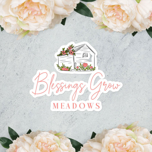 Blessings Grow Meadows Logo Bubble-free stickers by Blessings Grow Meadows feature pink and white corner flowers, an illustrated white shed, and “Blessings Grow” text. Durable vinyl with high opacity adhesive ensures a smooth, bubble-free application.