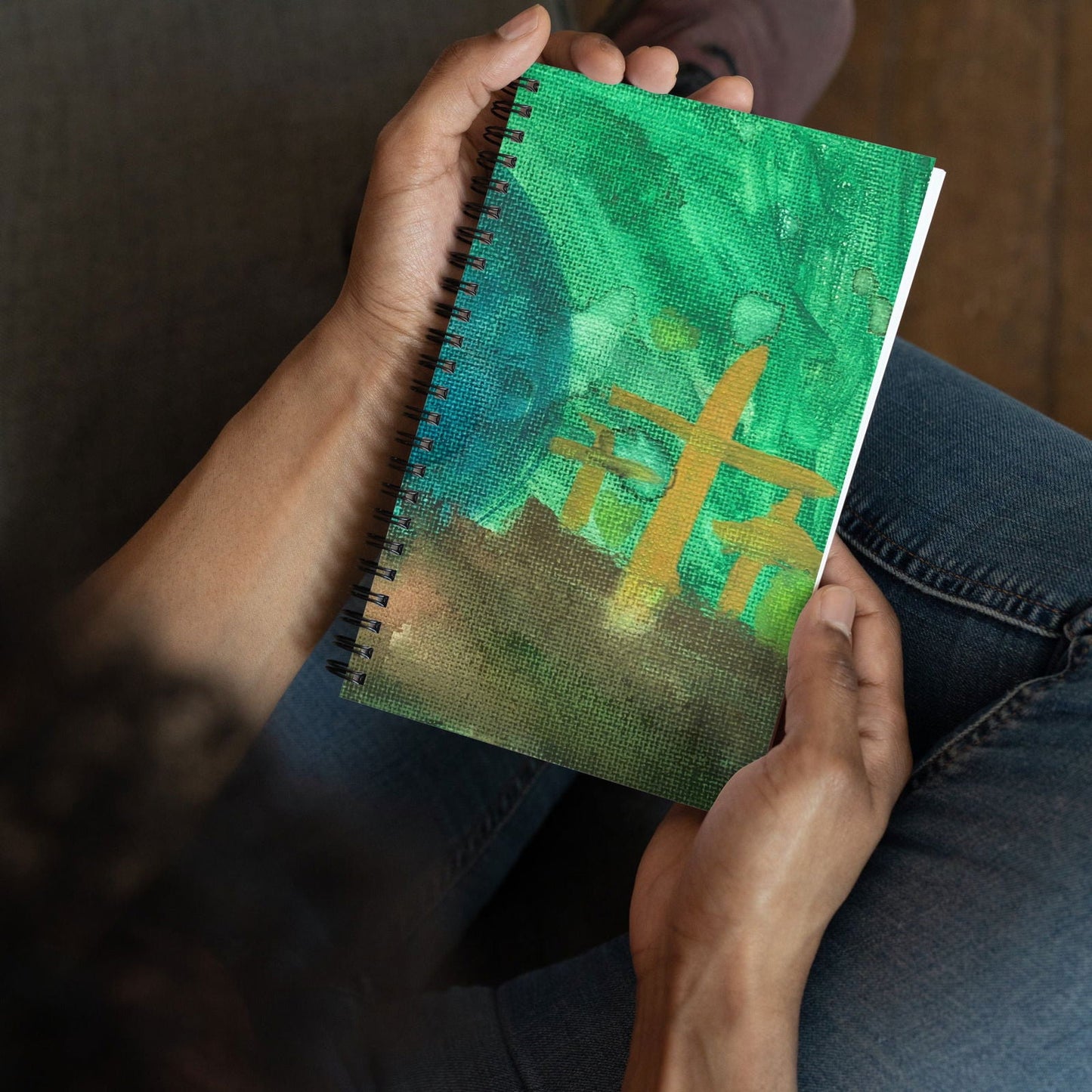 Spiral notebook featuring original artwork titled "He is Not Here" by Blessings Grow Meadows, with a colorful houseware design.