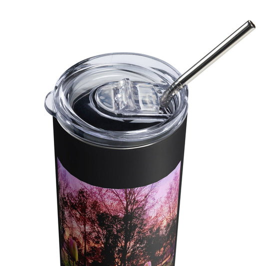 Stainless steel tumbler with a sunset landscape featuring pink trees and a single tulip showing a clear lid a stainless steel straw