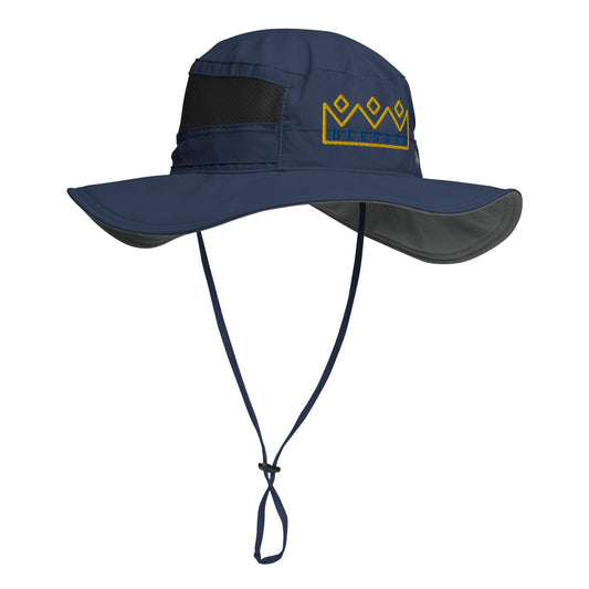 Product shot of a navy blue sun hat with a gold embroidered crown and Blessed text, featuring a black mesh panel and gray underbrim.