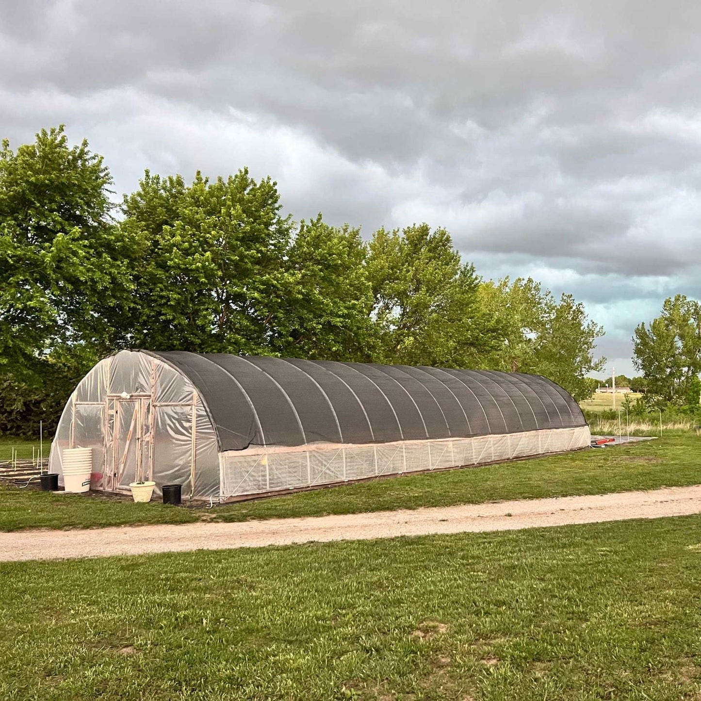 Bootstrap Farmer 20 ft wide DIY greenhouse kit with hoop house design, ideal for home gardening and plant protection.