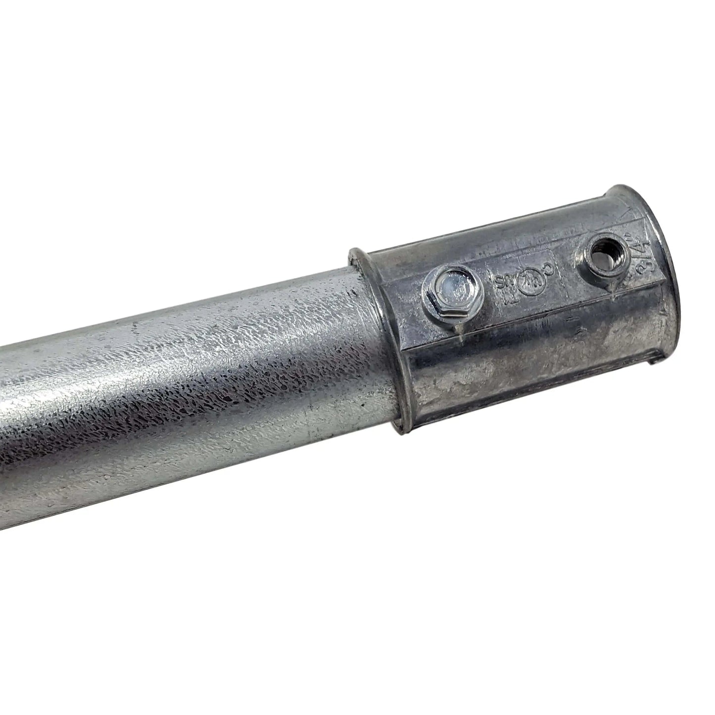 Close-up of a zinc-plated steel pipe with a 3/4 inch Die Cast EMT Coupling by Bootstrap Farmer, secured with a bolt and nut. The pipe is textured, while the smooth coupling features predrilled holes near the bolt.