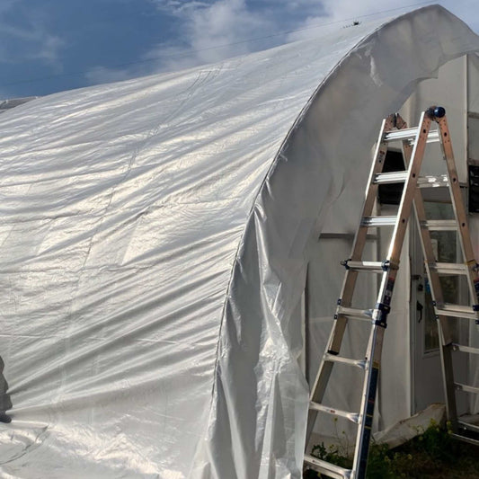 Greenhouse woven plastic cover by Bootstrap Farmer, 11 mil Solarig 182, used for greenhouse protection and climate control.