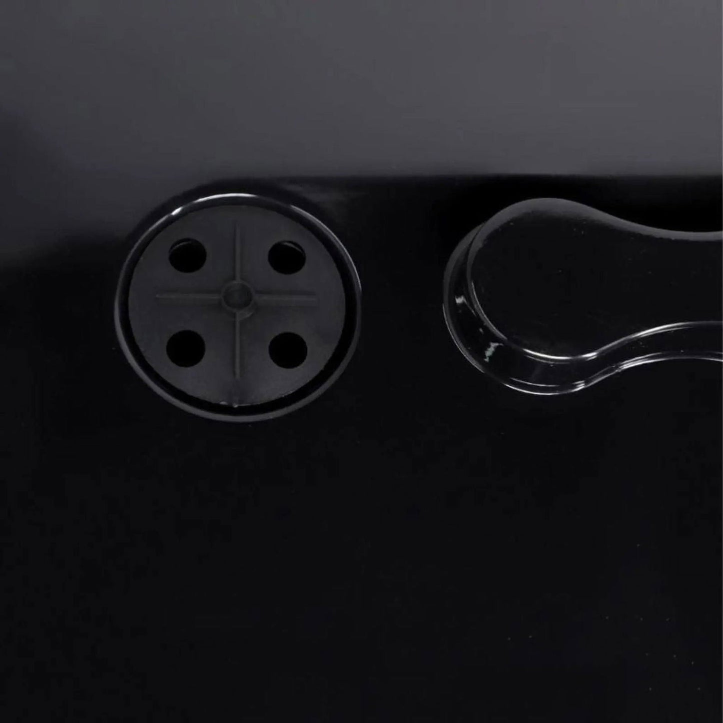 A close-up of the Bootstrap Farmer 1020 Blackout Humidity Dome shows a black surface with a four-hole circular drain on the left and a clear, curved handle on the right—ideal for extra strength use with 1020 trays.