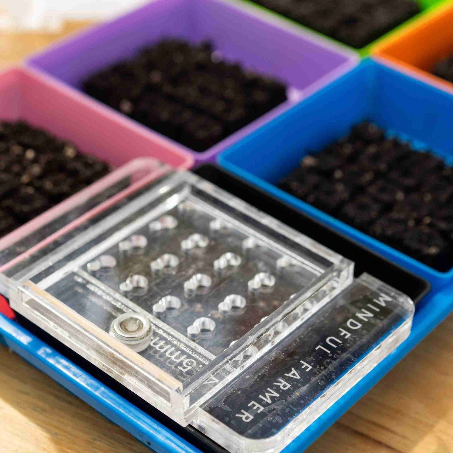Bootstrap Farmer Soil Block Drop Seeder Mini 20 set for planting seeds, featuring a compact seeding tool for efficient seed starting.