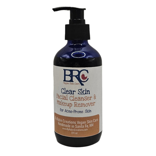 By Robin Creations Clear Skin Facial Cleanser with organic cotton makeup remover pads for acne-prone skin, in a glass pump bottle.