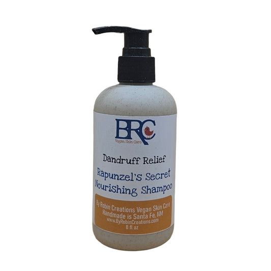 By Robin Creations liquid dandruff relief shampoo in biodegradable pump bottle, 8 oz, with clear label and sleek design.