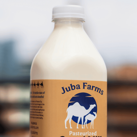 1-liter bottle of Juba Farms camel milk showing the transparent bottle and camel milk inside.