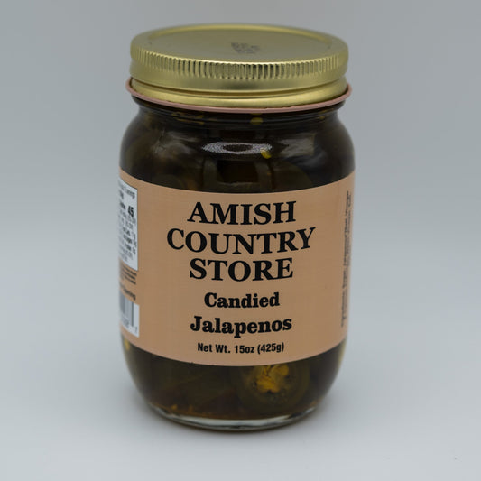 Canned candied jalapenos in a jar showing glossy, sliced jalapenos coated with sweet glaze, from Amish Country Store canned goods.