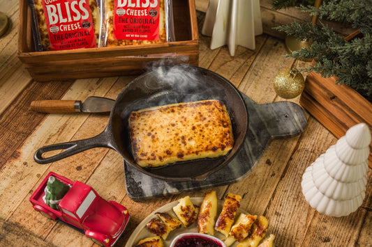 Golden Baked Bliss Cheese by Cheese Brothers, Inc., showcases a baked cheese pack with golden, crispy edges and melted cheese inside.